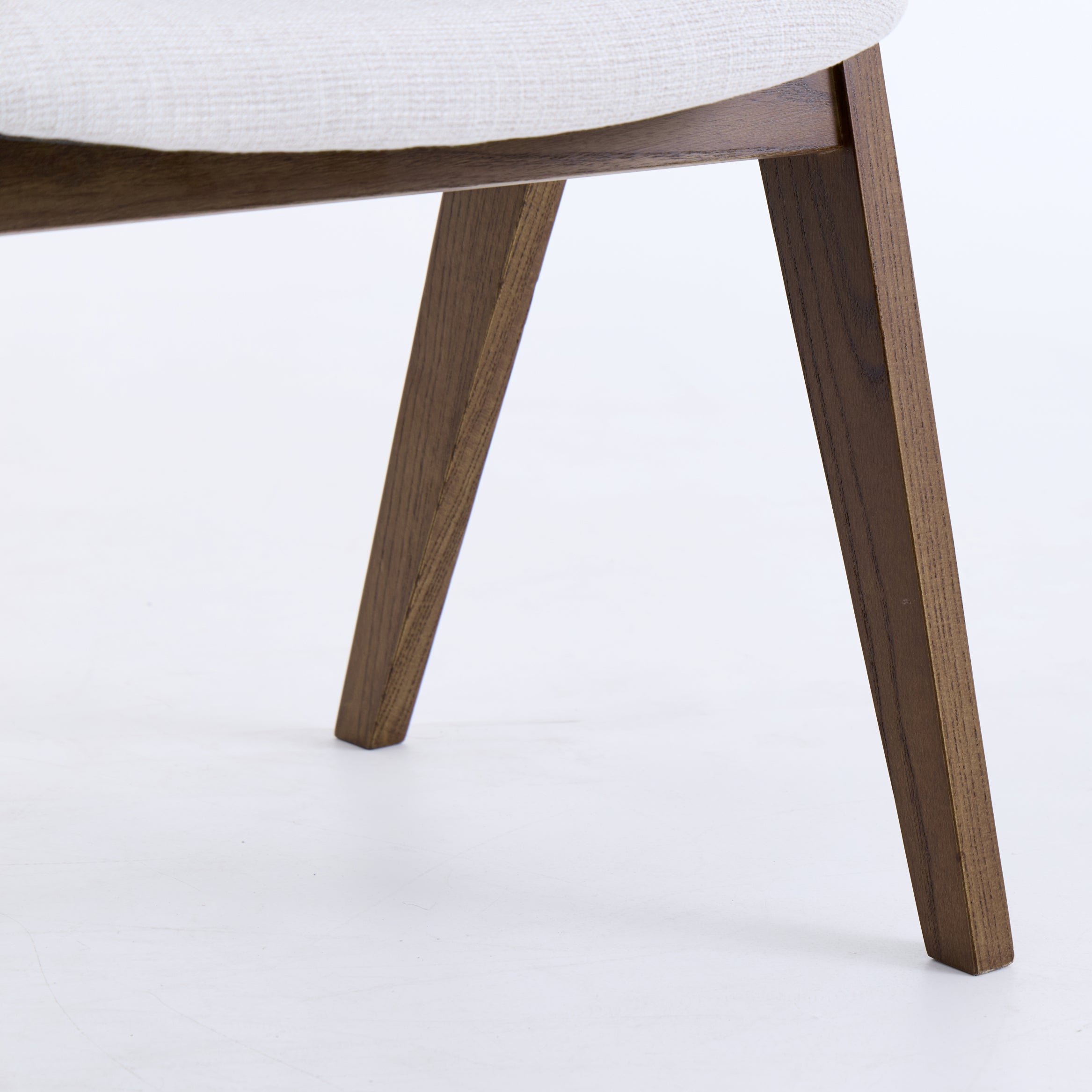 Close-up of a chair with wooden legs on a white background