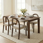 Dining room with a wooden table and chairs set, decorated with a vase of flowers.