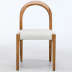 Wooden chair with a white cushioned seat on a light gray background
