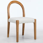 Wooden chair with a white cushion on a light gray background