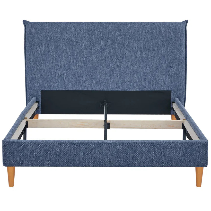 Blue upholstered bed with wooden legs on a white background