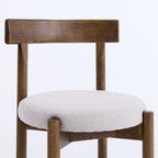 Wooden chair with a white cushion on a light purple background