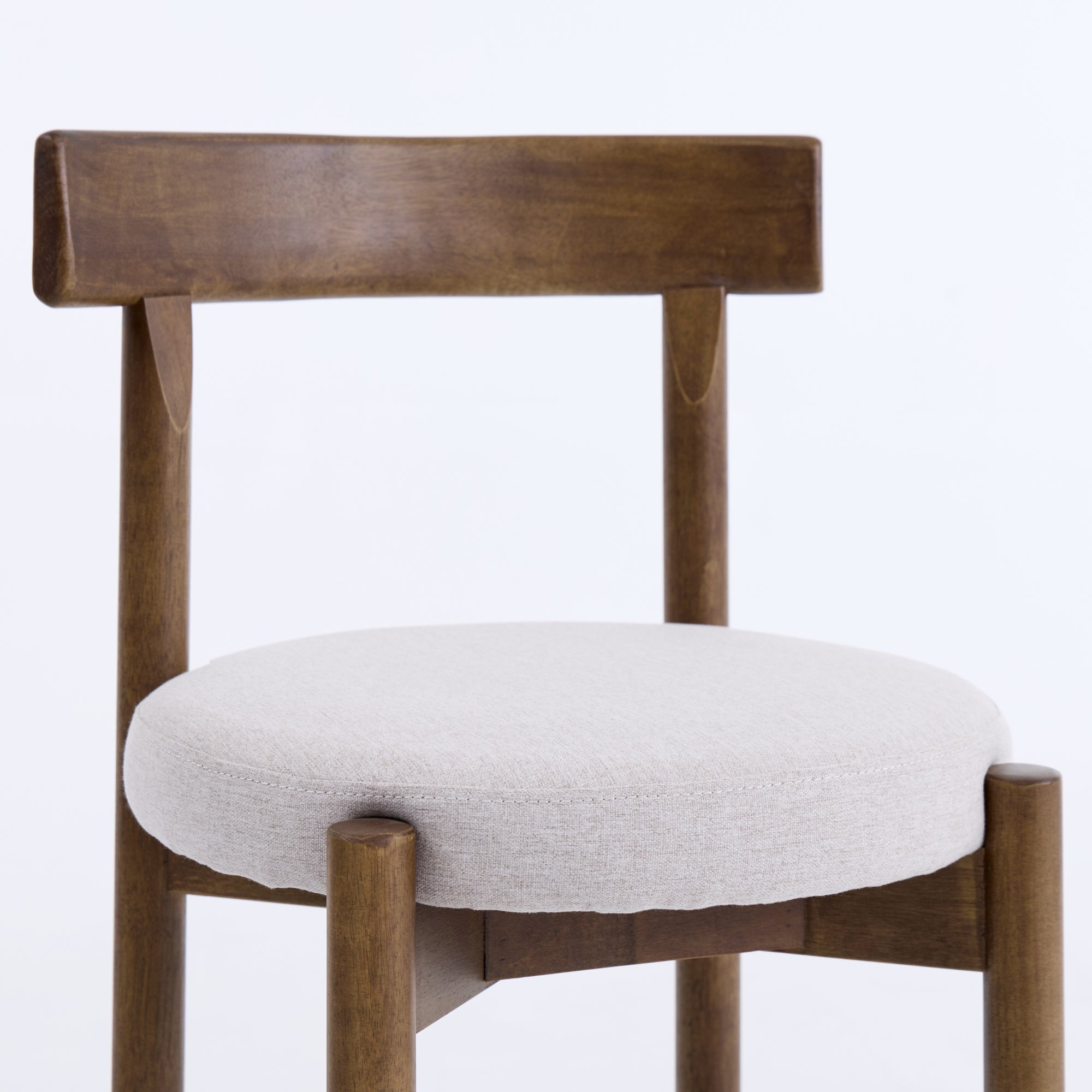 Wooden chair with a white cushion on a light purple background