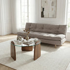 Modern living room with a gray sofa, glass coffee table, and abstract art on the wall.