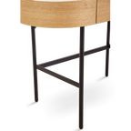 Bar stool with woven seat and black metal legs on a white background
